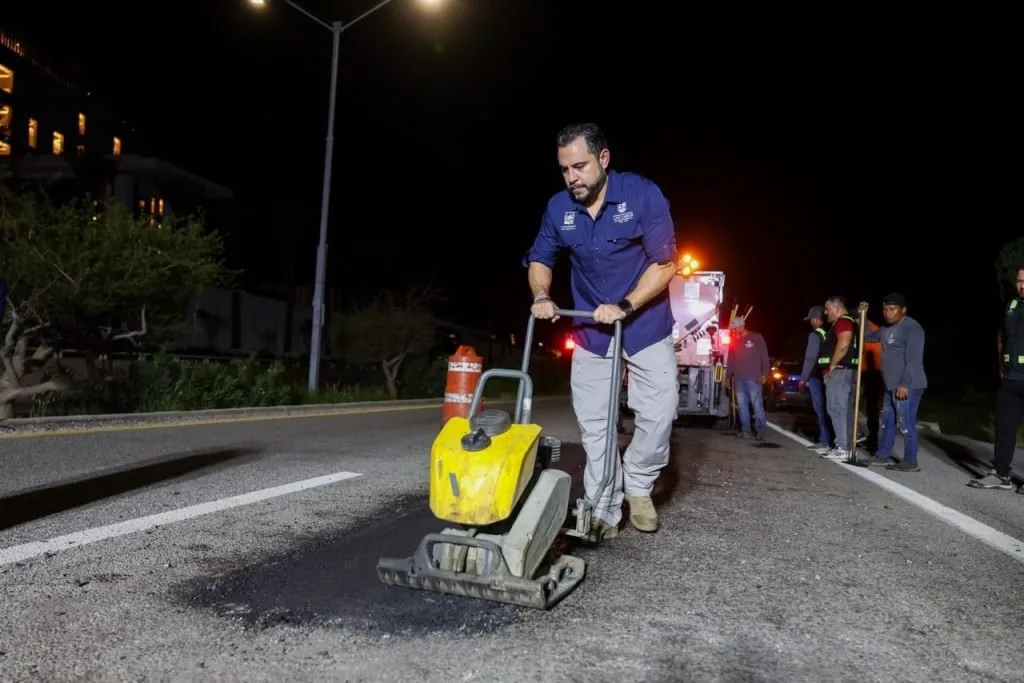 Public Works crew patching potholes at night on the Los Cabos tourist corridor