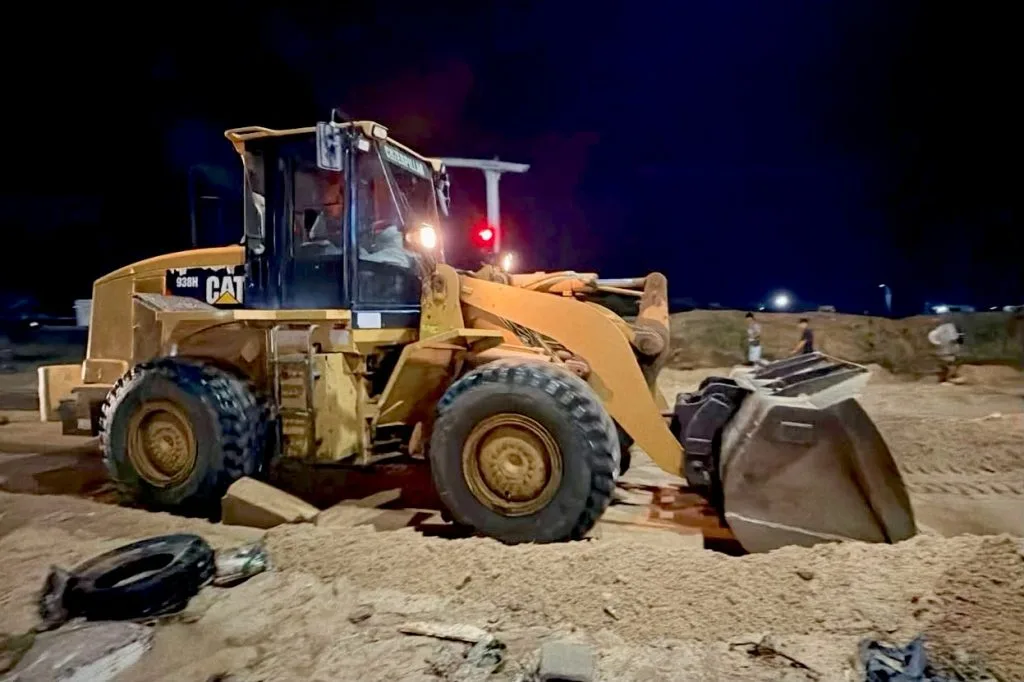Heavy machinery clears mud from a road in Cabo San Lucas