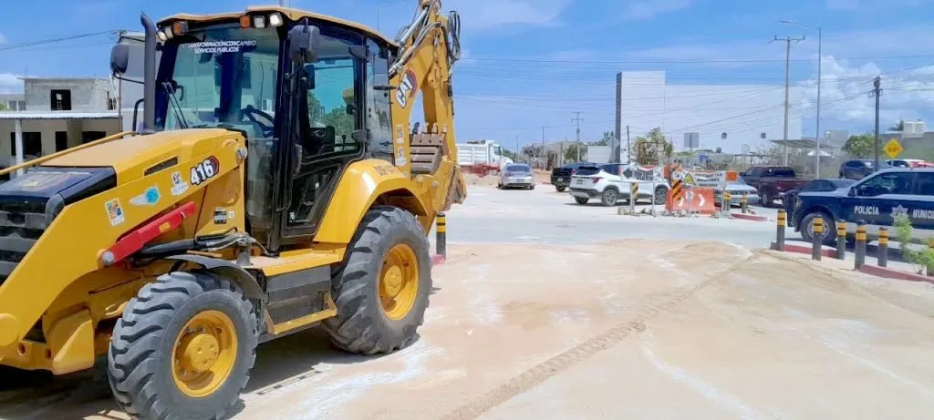 City machinery levels a rain-damaged street in Los Cabos